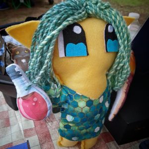 Hand-sewn elf plush holding a potion magnet in one hand and a torch in the other