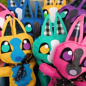 A group of colorful hand sewn animal plush