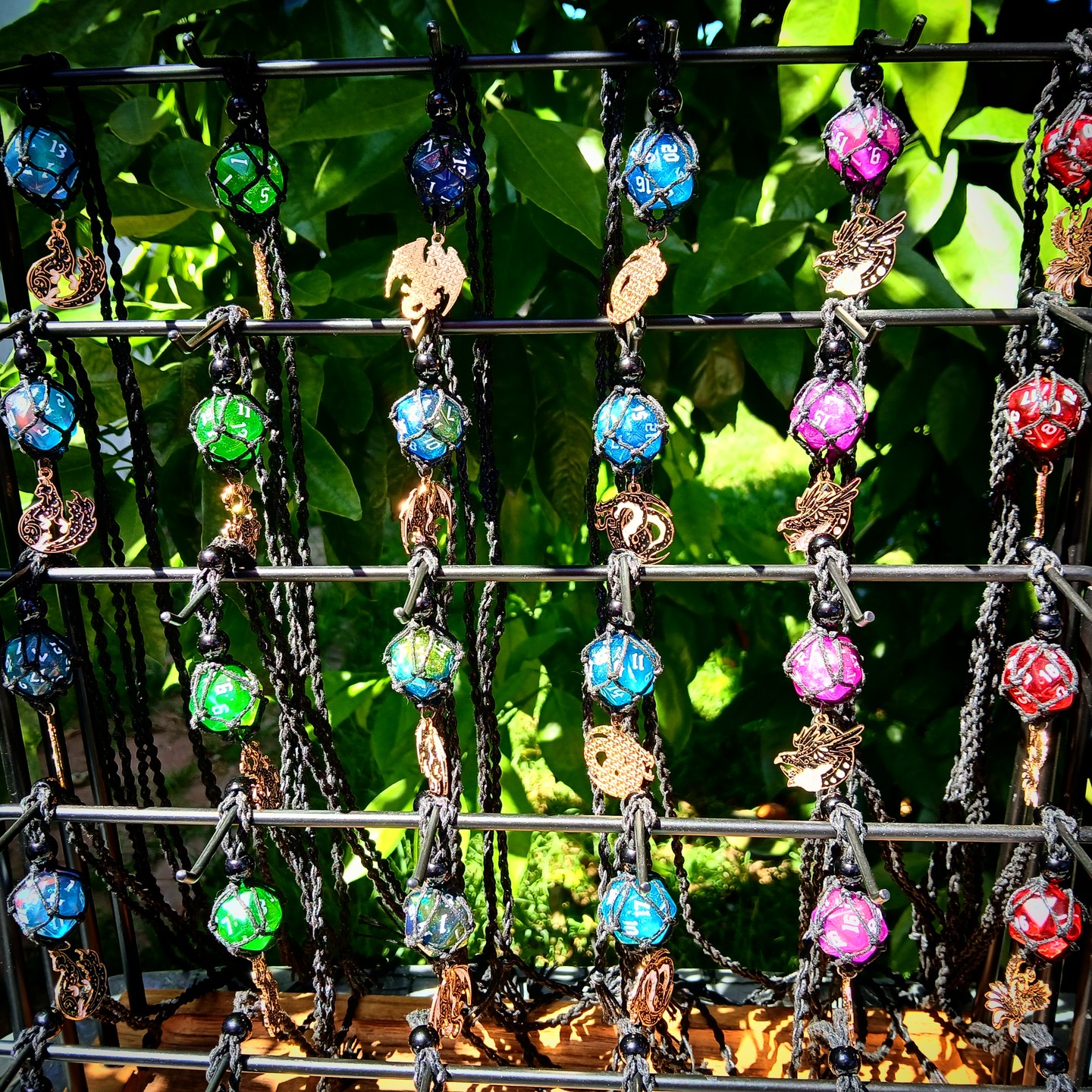 Dice necklaces in many colors and designs on a tiered display